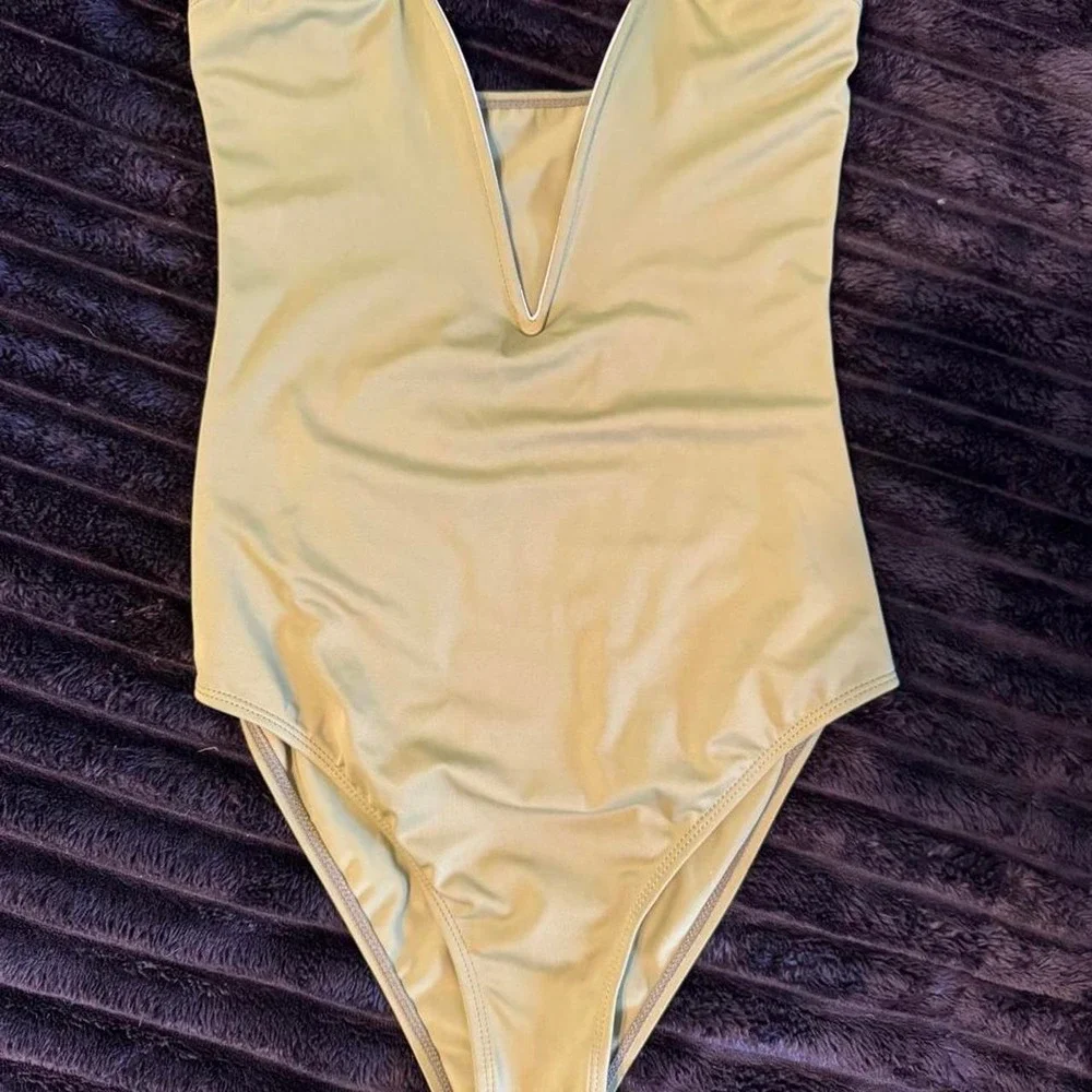 Green one piece bodysuit. Can be worn as a bodysuit.